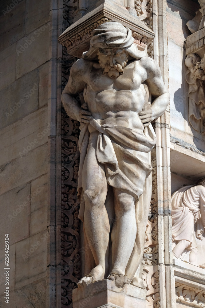 Obraz premium Atlantes supporting the main facade of the Milan Cathedral, Duomo di Santa Maria Nascente, Milan, Lombardy, Italy