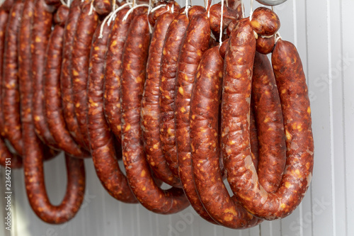 Chorizos cured and hung in strings (sausages)