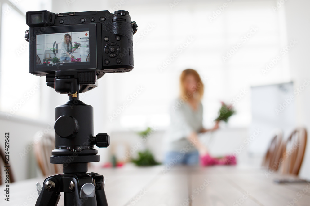 Bokeh image of woman florist composing bouquet of pink flowers. Bokeh image of woman florist composing bouquet of pink flowers.