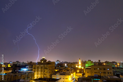 Lightning storm over city in purple light in jeddah al marwah photo