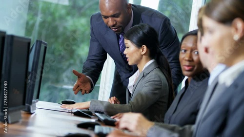 Ambitious African American male business manager giving multi ethnic team latest sales goals  photo