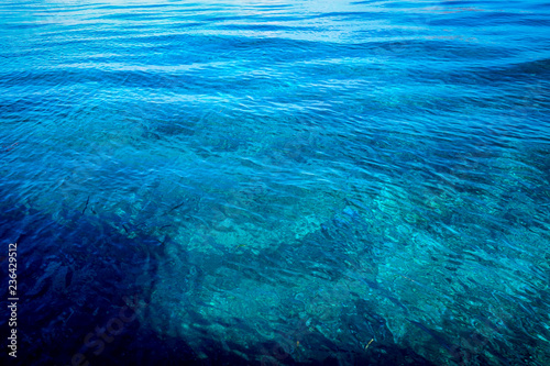 View of calm ripples in the surface of beautiful blue and turquoise tropical waters in Komodo National Park, Indonesia