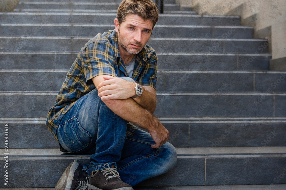 young sad and desperate man sitting outdoors at street stairs suffering anxiety and depression feeling miserable crying in unemployment and broken heart concept young sad and desperate man sitting outdoors at street stairs suffering anxiety and depression feeling miserable crying in unemployment and broken heart concept