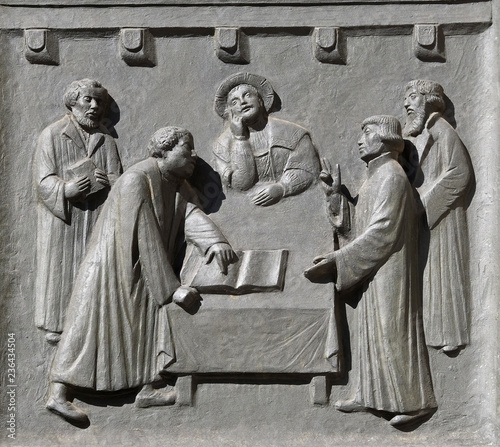 Luther and Zwingli dispute about the Lord's Supper at Marburg, relief on the door of the Grossmunster (