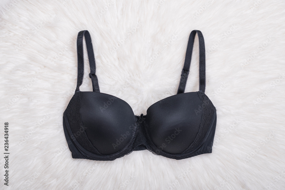 Black bra on white fur. Lingerie. Fashion concept Black bra on white fur. Lingerie. Fashion concept