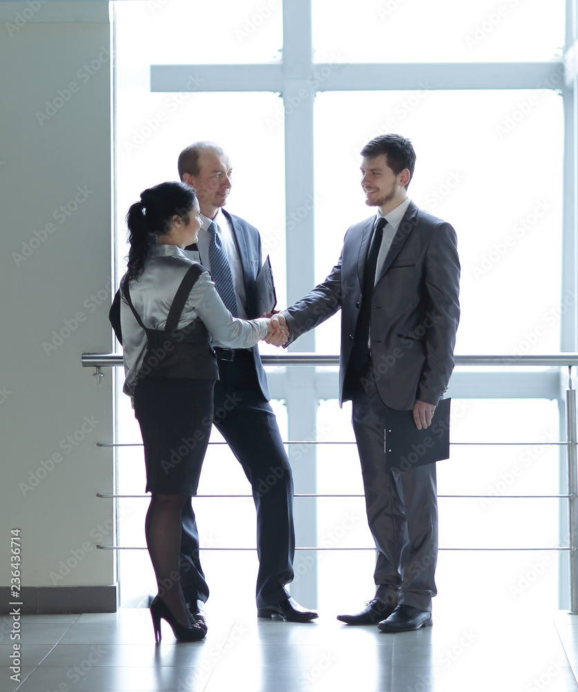 Manager welcomes the client in the lobby office Manager welcomes the client in the lobby office