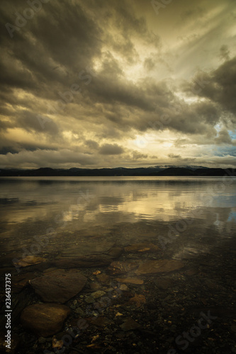 Sunset sky reflections in Jonsvatnet lake  Norway.