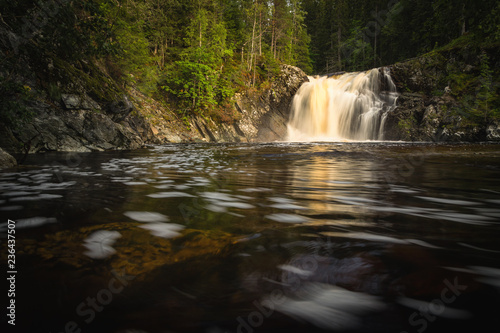 Long exposure shot of flowing river Homla and waterfalls.