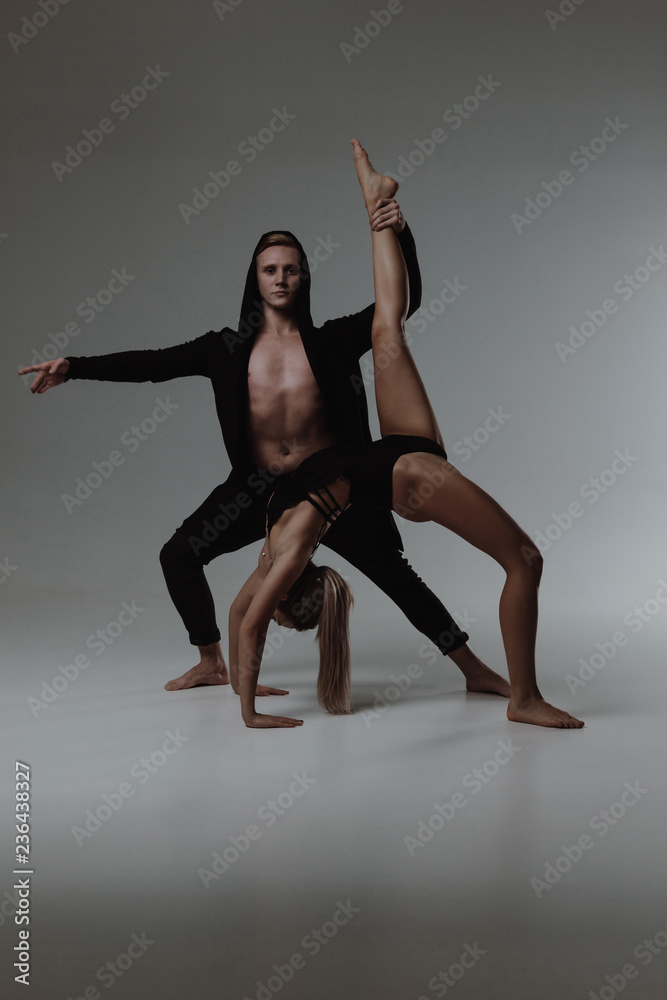 Two young modern ballet dancers in studio