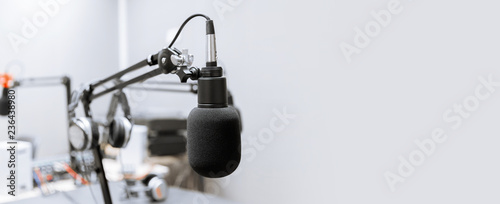 technology and audio equipment concept - microphone at recording studio or radio station