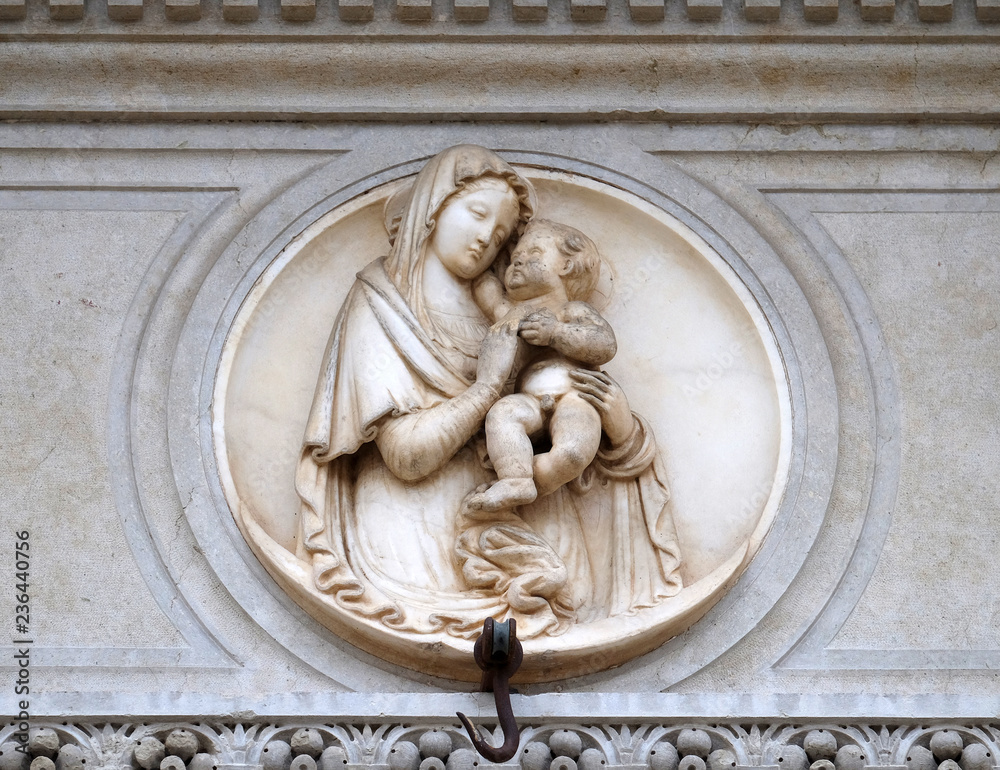 Virgin Mary with baby Jesus, relief on the portal of the Cathedral of Saint Lawrence in Lugano, Switzerland