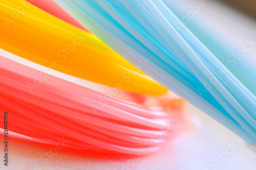 ABS plastic (yellow, blue, pink) on a whte background.