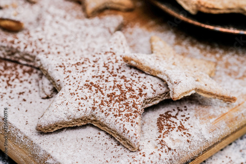 Star shaped christmas cookies decorated sugar and cocoa powder