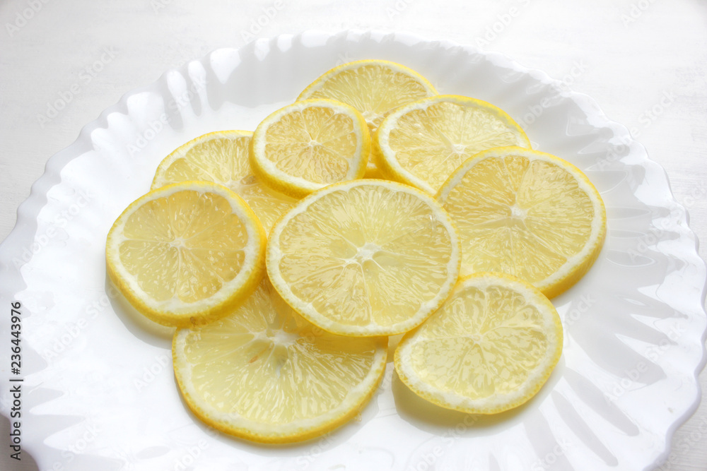 Slices of lemon on a white Slices of lemon on a white