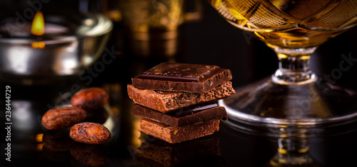 Photography Chocolate with brandy on dark background