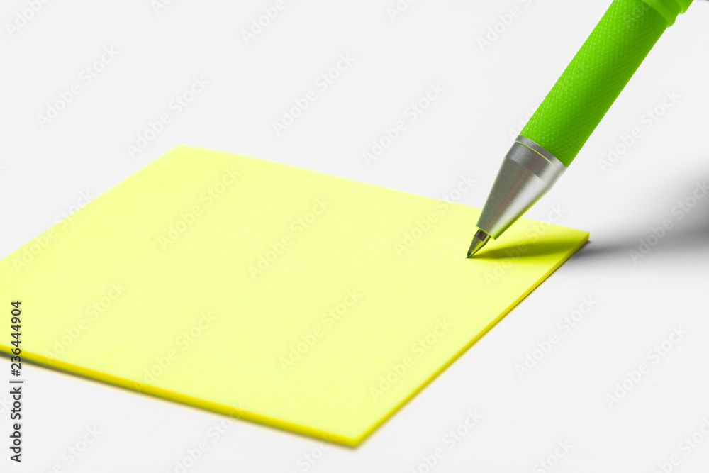 Blank memo pad note with pen close up Blank memo pad note with pen close up