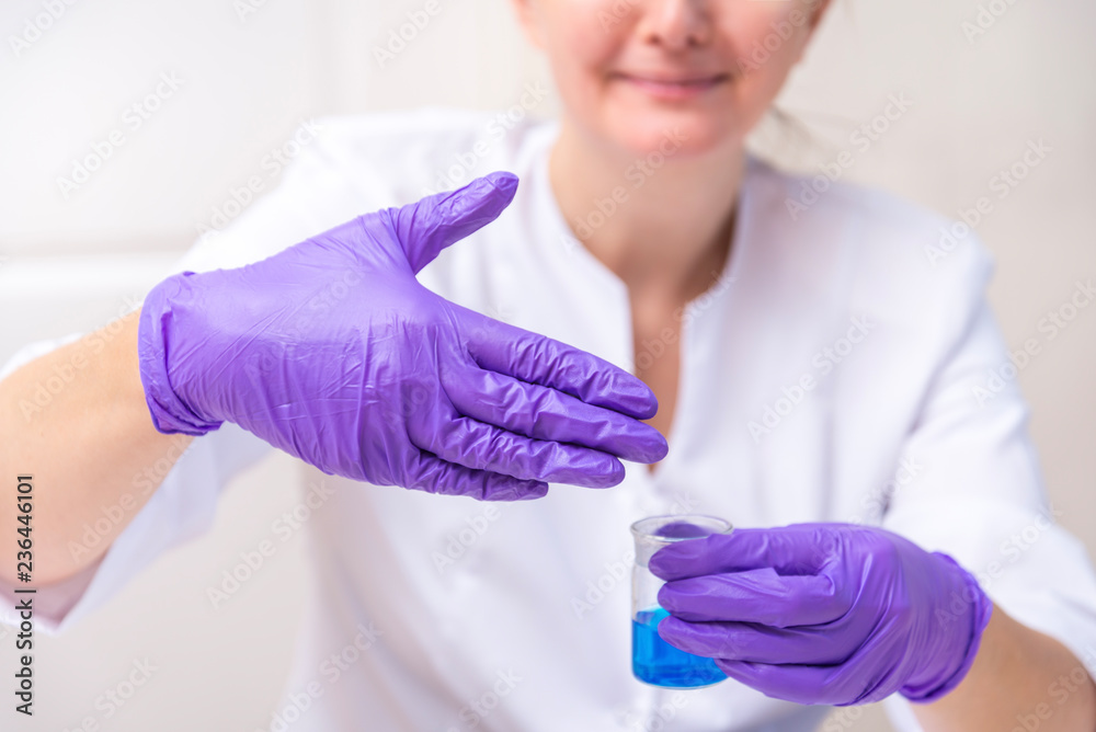 Woman holding laboratory reagent, disgusting smell Woman holding laboratory reagent, disgusting smell