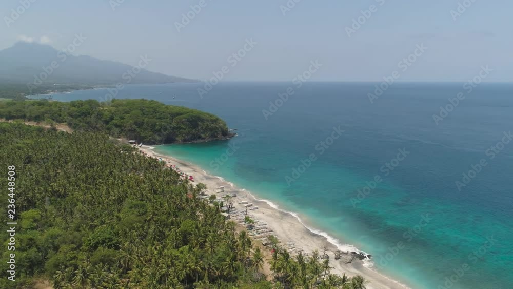 sandy beach with palm trees in tropical resort. aerial seascape sand beach with turquoise water. Seascape, ocean and beautiful beach.Travel concept. Indonesia, Bali sandy beach with palm trees in tropical resort. aerial seascape sand beach with turquoise water. Seascape, ocean and beautiful beach.Travel concept. Indonesia, Bali