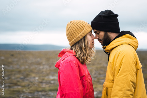 Young couple rubbing affectionately noses, Lapland, Norway