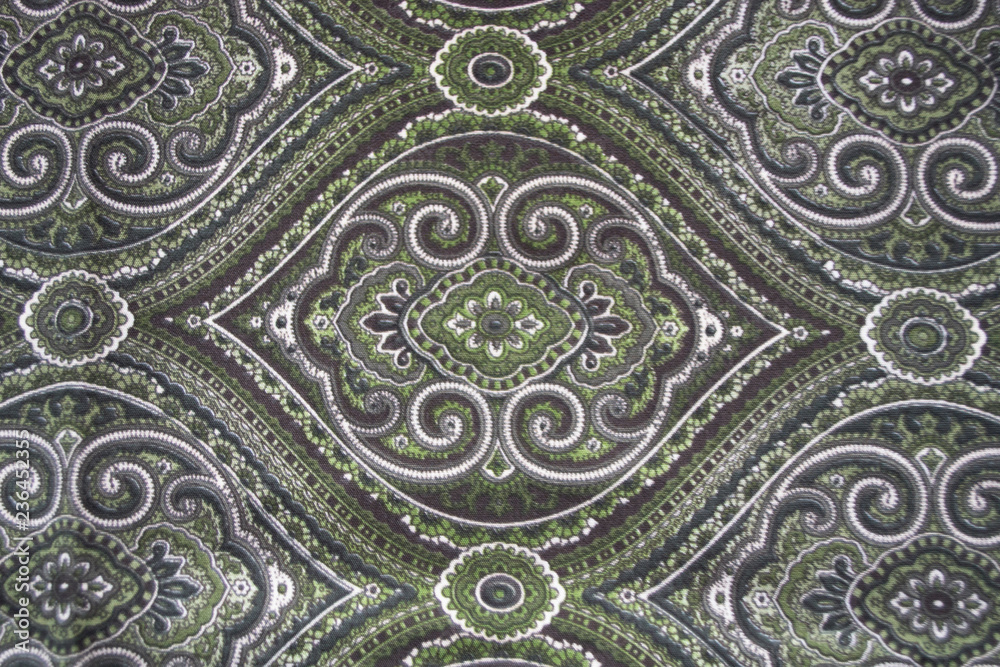 Background. East pattern on fabric. Khaki, green.