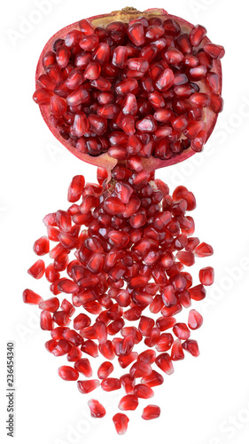Cut the pomegranate with scattered grain top view isolated