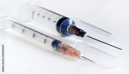 Disposable syringe. Plastic insulin syringe. The insulin syringe with the lid open shows sharp needles. Injection medicine. Medical equipment. photo
