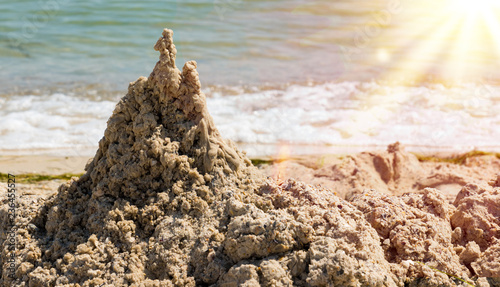 large pile of wet sand on the beach © nndanko