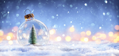 Snow Ball With Christmas Tree In It And Lights On Winter Background
