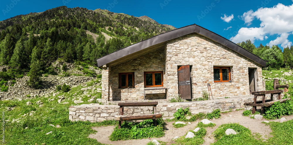 A public stone house is an open free shelter for all travelers and hikers in the mountains of the Pyrenees