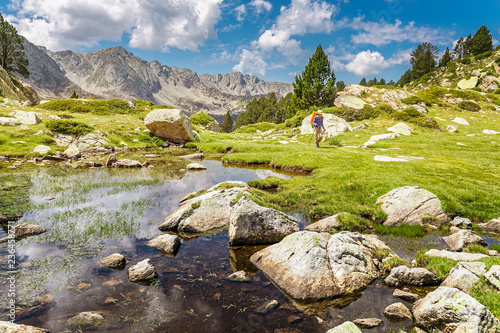 Impressive view of Pyrenees landscape in Andorra, with woman hiker photo