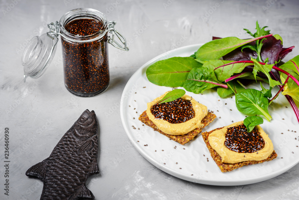 Vegan caviar made with chia seeds and nori. Appetizers on whole grain crispbreads with hummus Vegan caviar made with chia seeds and nori. Appetizers on whole grain crispbreads with hummus