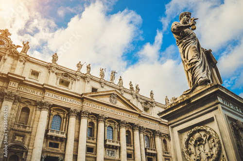 St. Peter's square, Vatican City, Roma. Low angle view of the statue of St. Peter with the front of the Basilica in the background