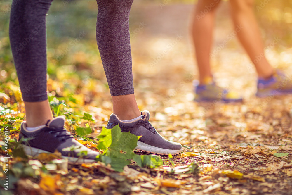 Running sport fitness woman. Close up of female legs and shoes. Girl athlete fitness runner running shoes. Trail running concept..