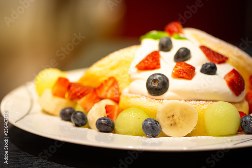 Pancake with strawberry, blueberry, banana, berry sauce and mascarpone cheese cream.