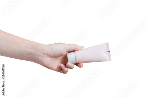 woman applying moisturizing hand cream. Pink tube in female's hands isolated on white background
