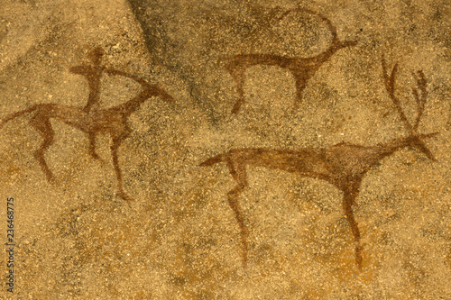 image of ancient hunting on the cave wall. history of antiquities, archeology.