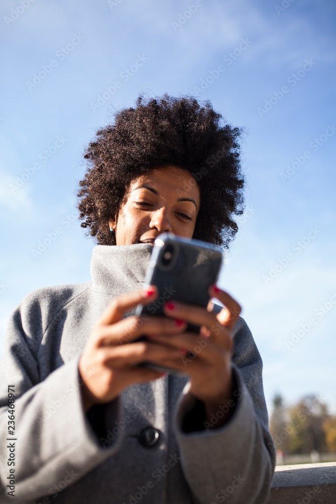 Fototapeta premium Afro woman having fun in the park