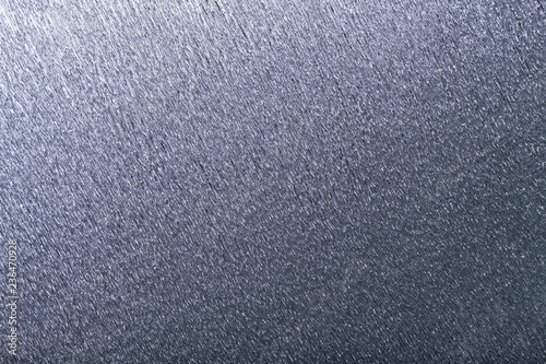 Textural of silver background of wavy corrugated paper, closeup.