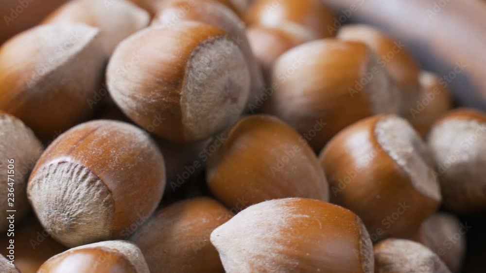 A pile of shelled hazelnuts rotating smoothly and slowly. Macro shot