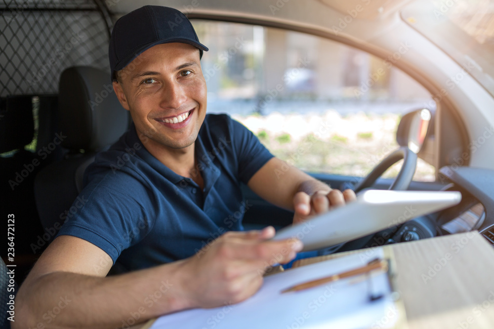 Delivery man sitting in a delivery van Delivery man sitting in a delivery van