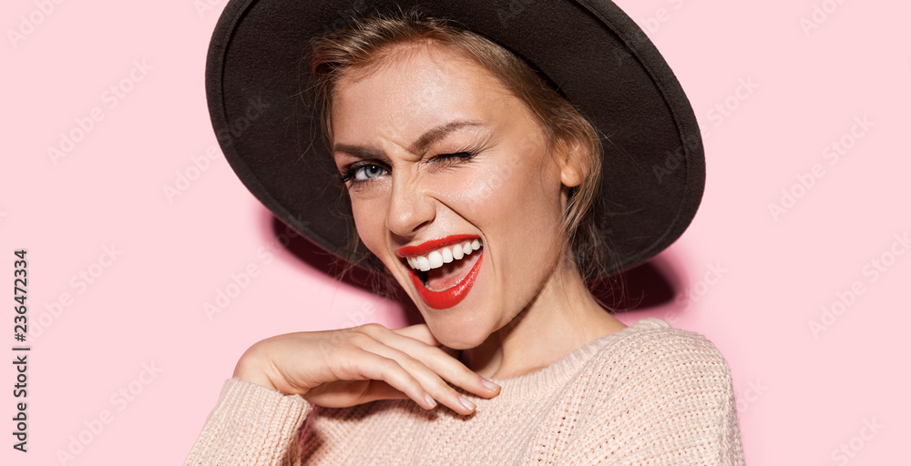 Close-up fashion portrait of gorgeous lady expressing happiness. Stylish female with beautiful smile and perfect makeup posing in studio on pink background - obrazy, fototapety, plakaty 