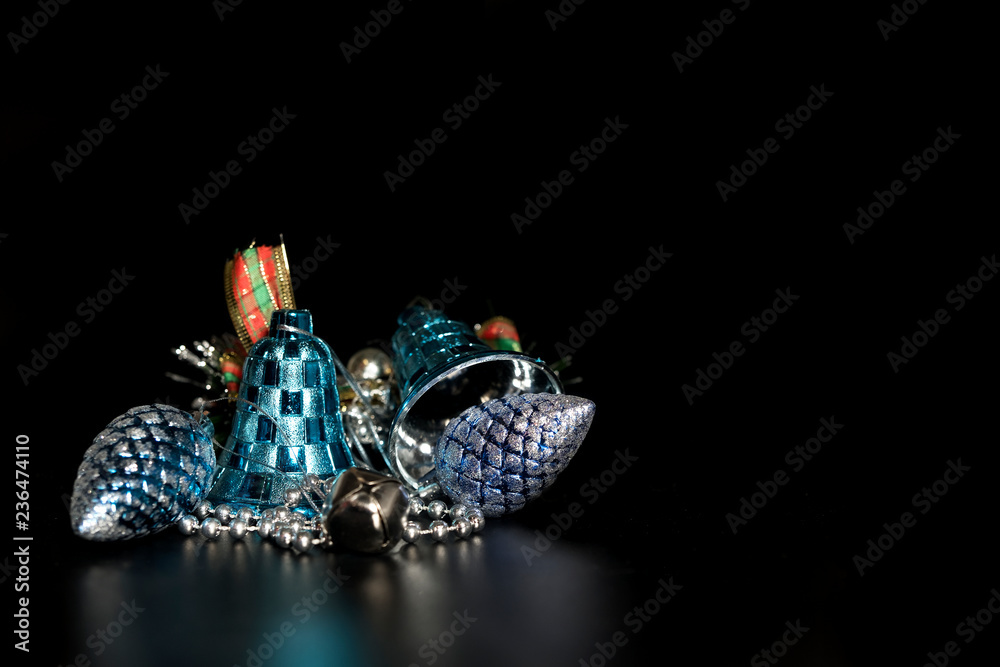 Fototapeta premium Christmas decorations with bells, on a black background.