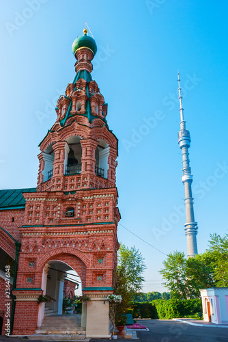 The belfry of the ornate Ostankino Life-giving Trinity Church and the modern Ostankino Tower on the bakground, Moscow, Russia. photo