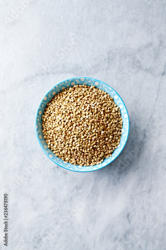 Organic Buckwheat in a Bowl on stone background. Healthy cooking with natural ingredients. Flatlay