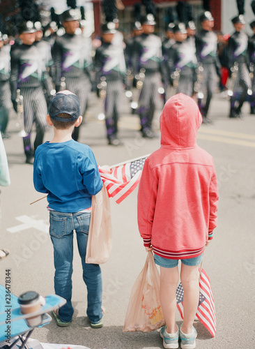 kids gathering candy at fourth of july parade photo