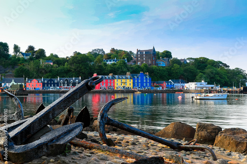 landscape shot of tobermory harbour with two anchors in the foreground on isle of mull in scotland