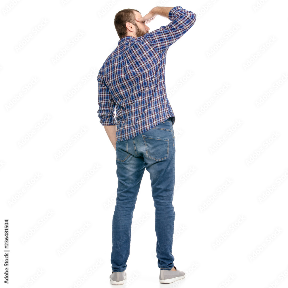 A man in jeans looks into the distance on a white background. Isolation A man in jeans looks into the distance on a white background. Isolation