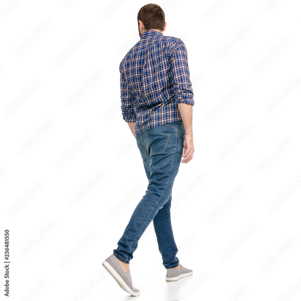 The man in jeans goes walking on a white background isolation back vi The man in jeans goes walking on a white background isolation back vi