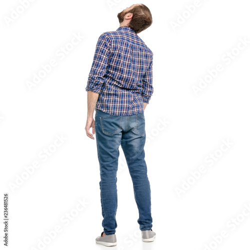 A man in jeans looking up on a white background isolation back view