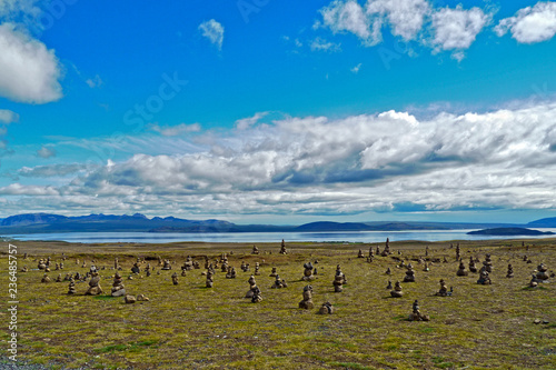 Iceland. Stone heaps at Thingvellir National Park with the Thingvallavatn Lake in the background